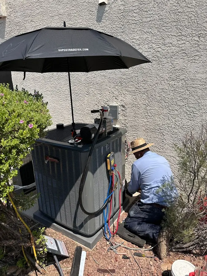 HVAC technician performing outdoor AC maintenance in Fultondale